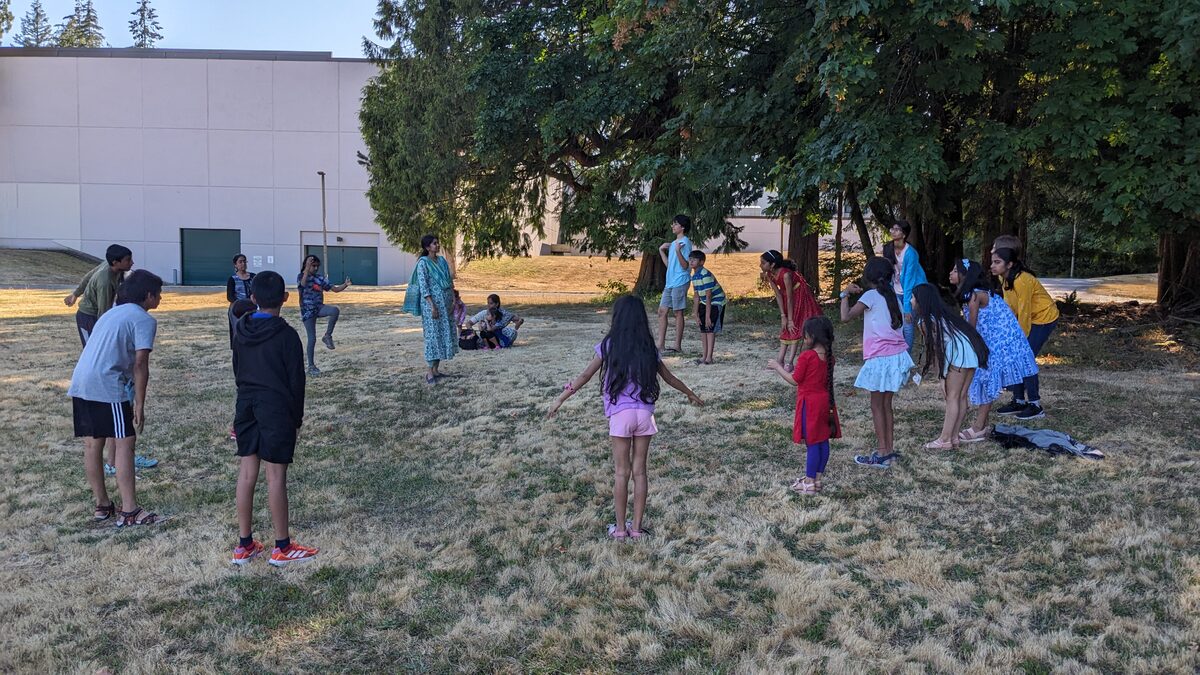 Kids playing games outdoors at Vitastaa camp