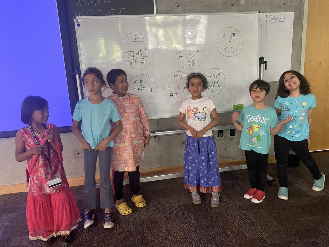 Kids learning Devanagari at the whiteboard